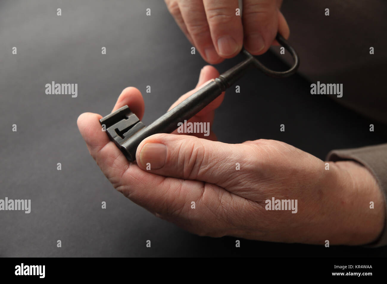 Man holding a vintage key with copy space Stock Photo