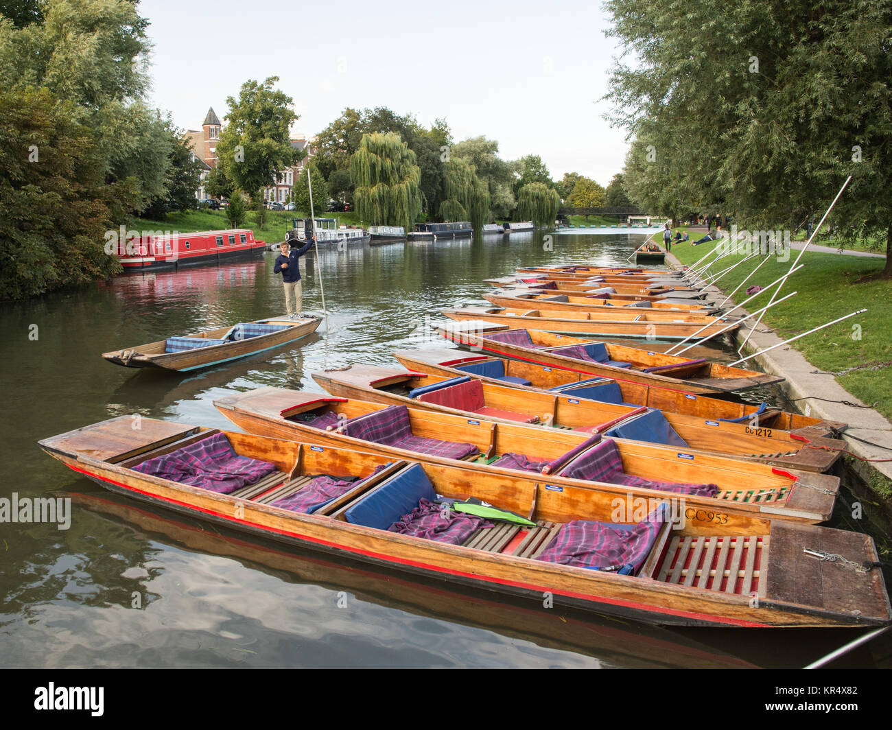 Cambridge, England, UK - August 19, 2017: Traditional punt boats are moored up on the riverbank of the Cam in Cambridge. Stock Photo