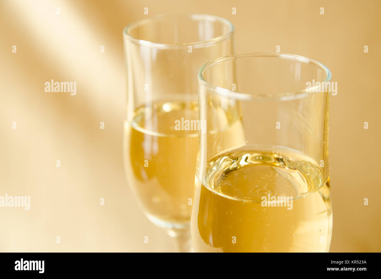 two glasses of champagne on a background of a fabric of golden color Stock Photo
