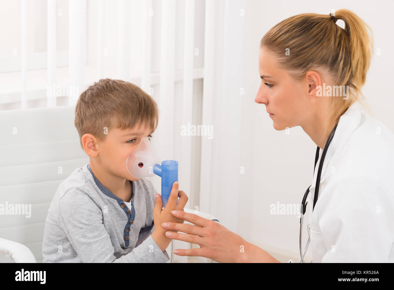 Child Patient Inhaling Through Oxygen Mask Stock Photo