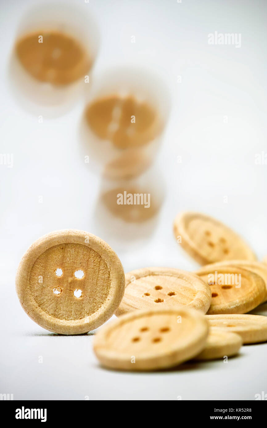 Knoepfe aus Holz stehend,liegend,fallend vor hellem Hintergrund Stock Photo