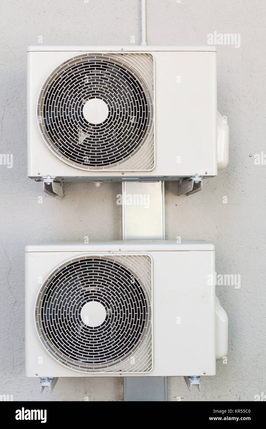 Two compressors for air conditioners. Installed on the wall Stock Photo
