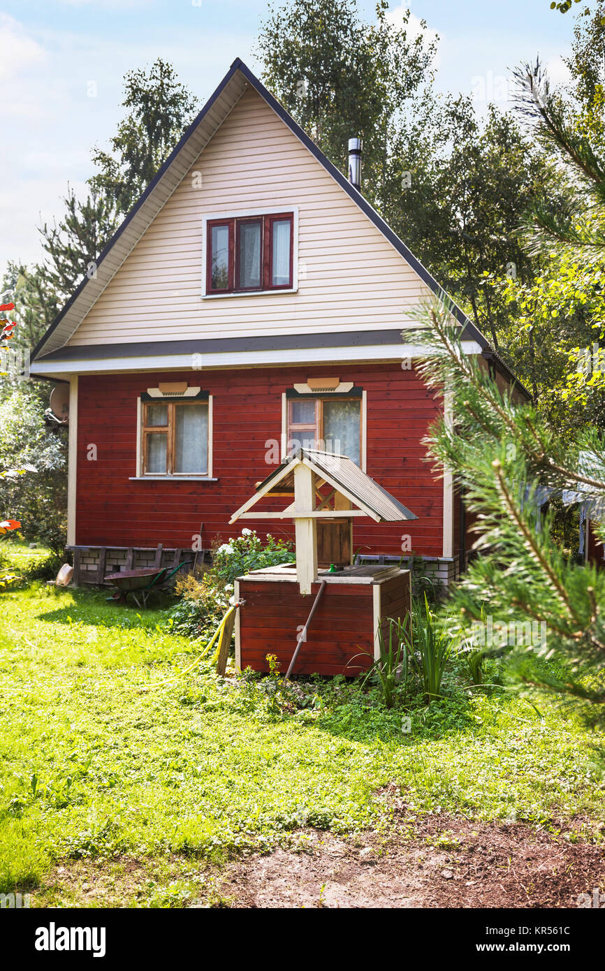 Draw Well In Front Of Little Country Cottage Stock Photo