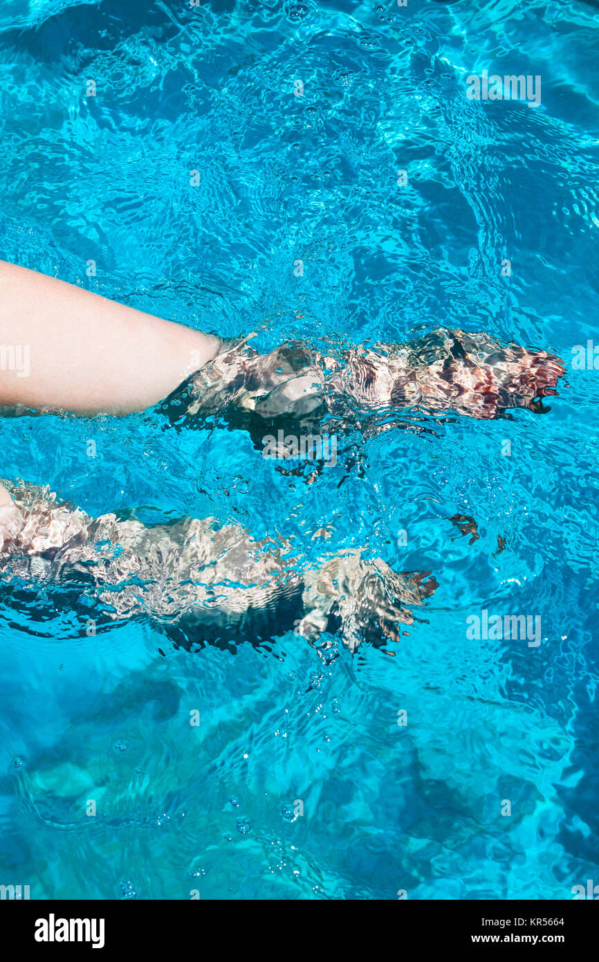 female legs flounder in blue water Stock Photo Alamy