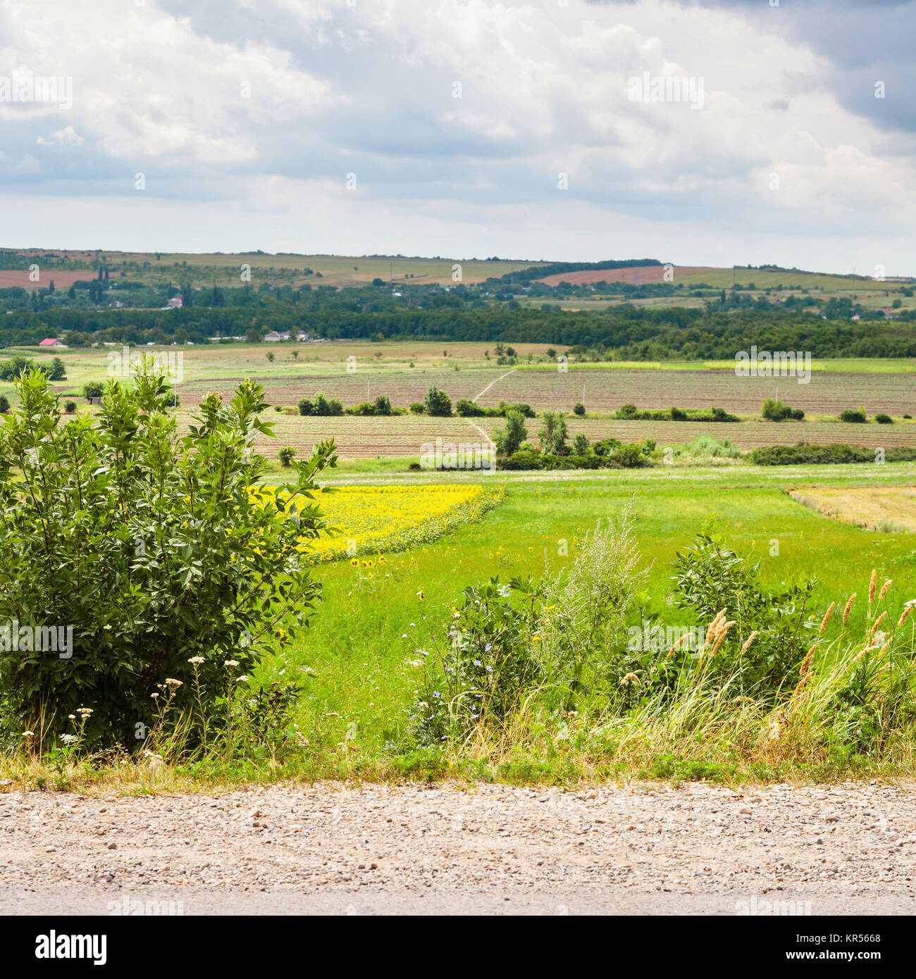 country landscape with road, fields and village Stock Photo