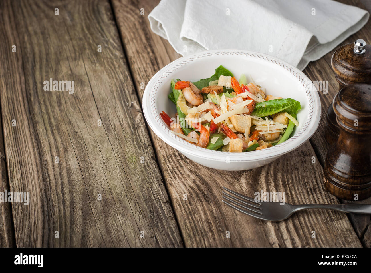 Salad with shrimps , croutons  and greens on the wooden table horizontal Stock Photo