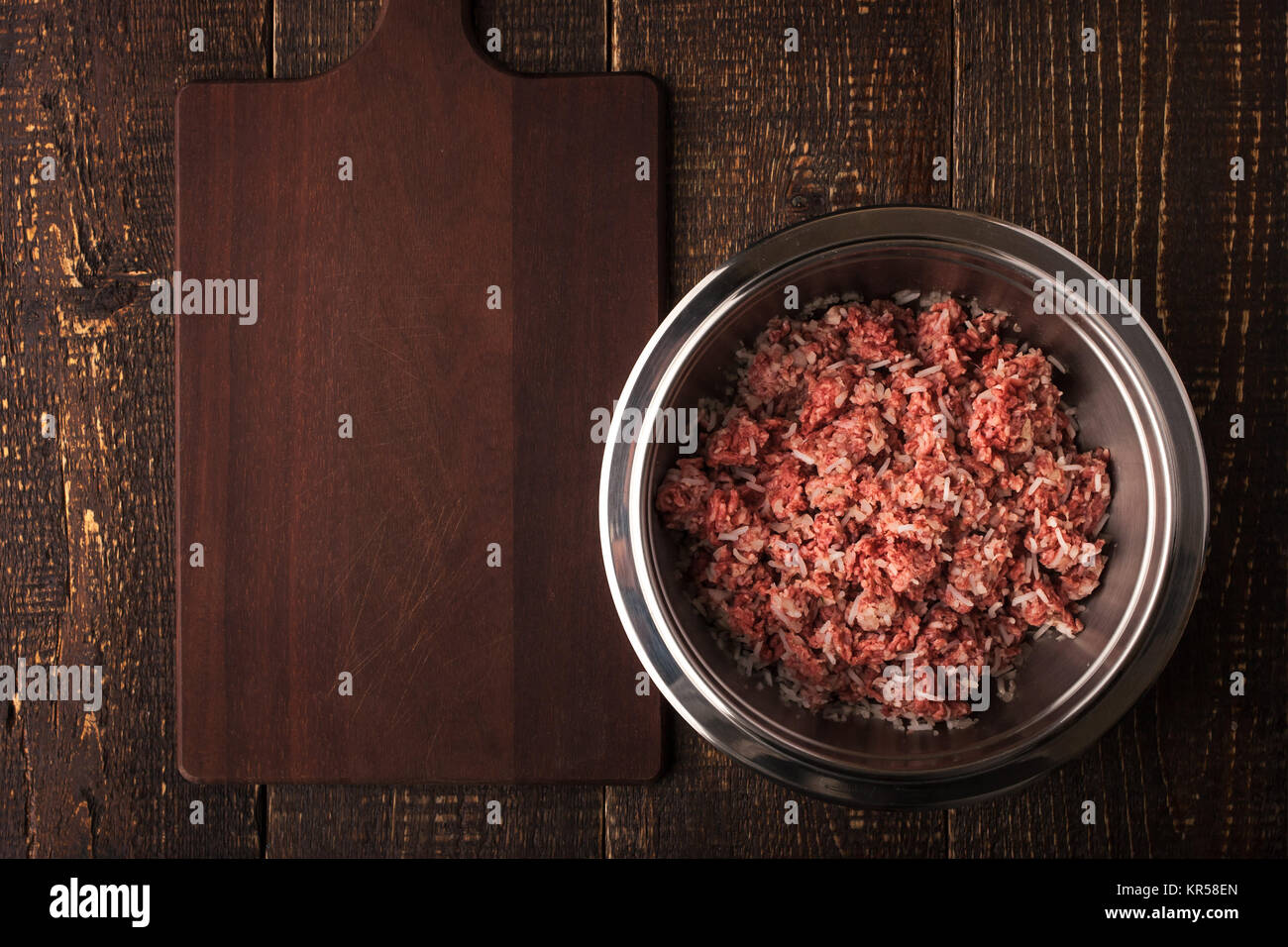 Ground beef with rice in the metal pan  on the wooden table top view Stock Photo