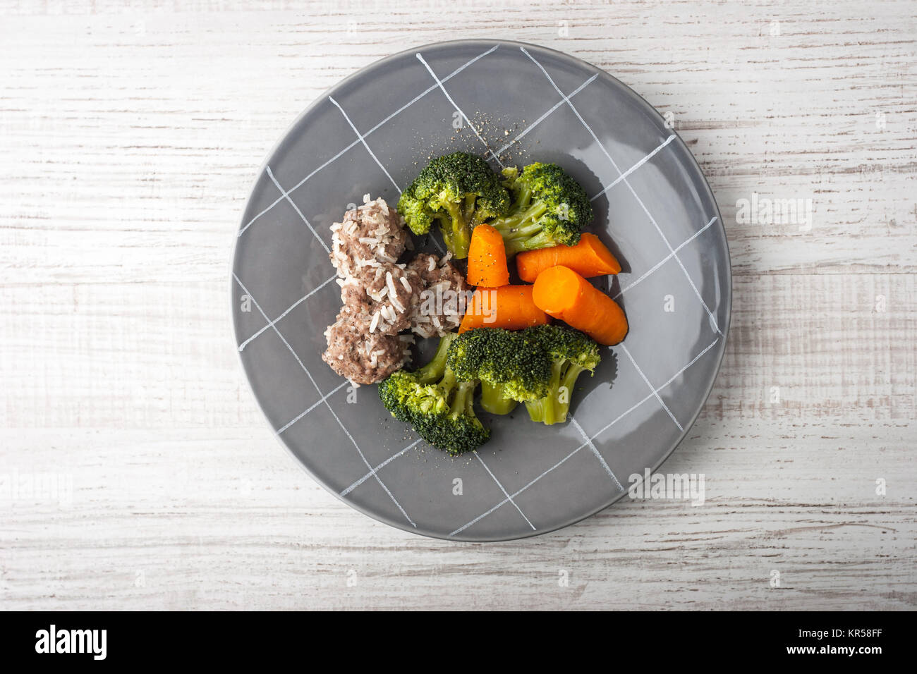 Meatballs with steamed vegetables on the gray plate top view Stock Photo