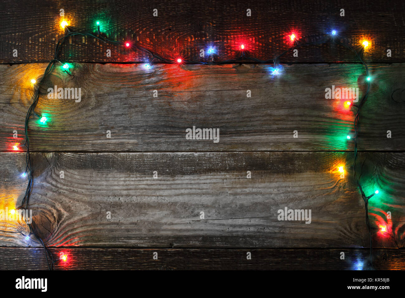 Frame of the colorful Christmas festoon on the wooden board Stock Photo