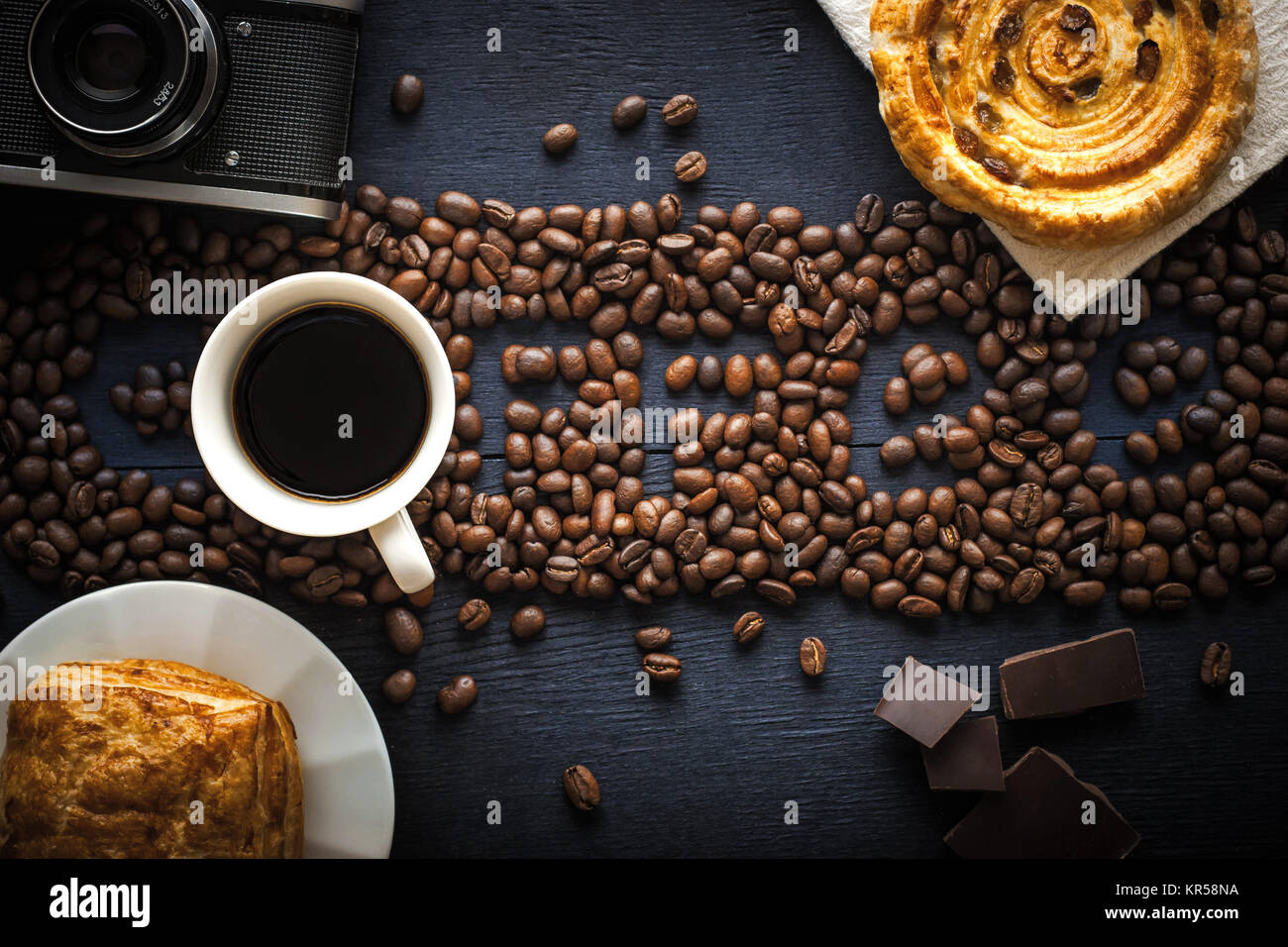 Coffee word made by coffee beans with camera  chocolate , pastry and cup of coffee Stock Photo