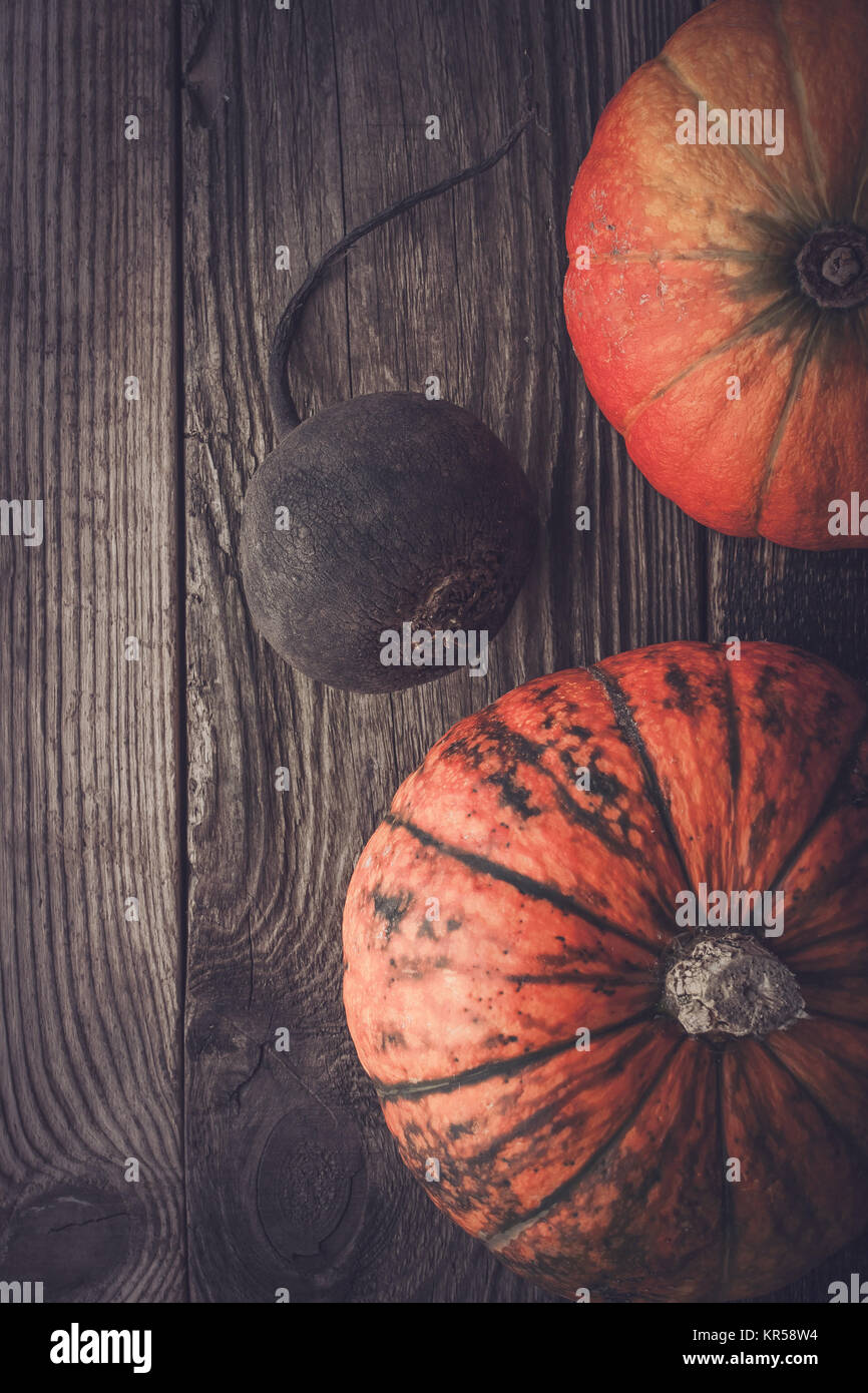 Turnip and two pumpkins on the wooden table Stock Photo