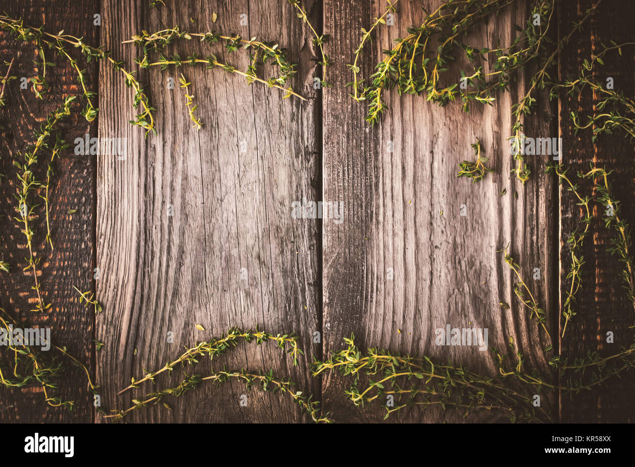Frame of the thyme sprigs on the wooden board horizontal Stock Photo