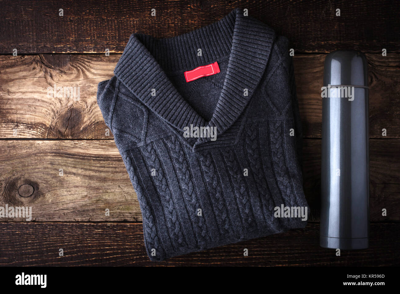 Grey sweater and thermos on the wooden background Stock Photo