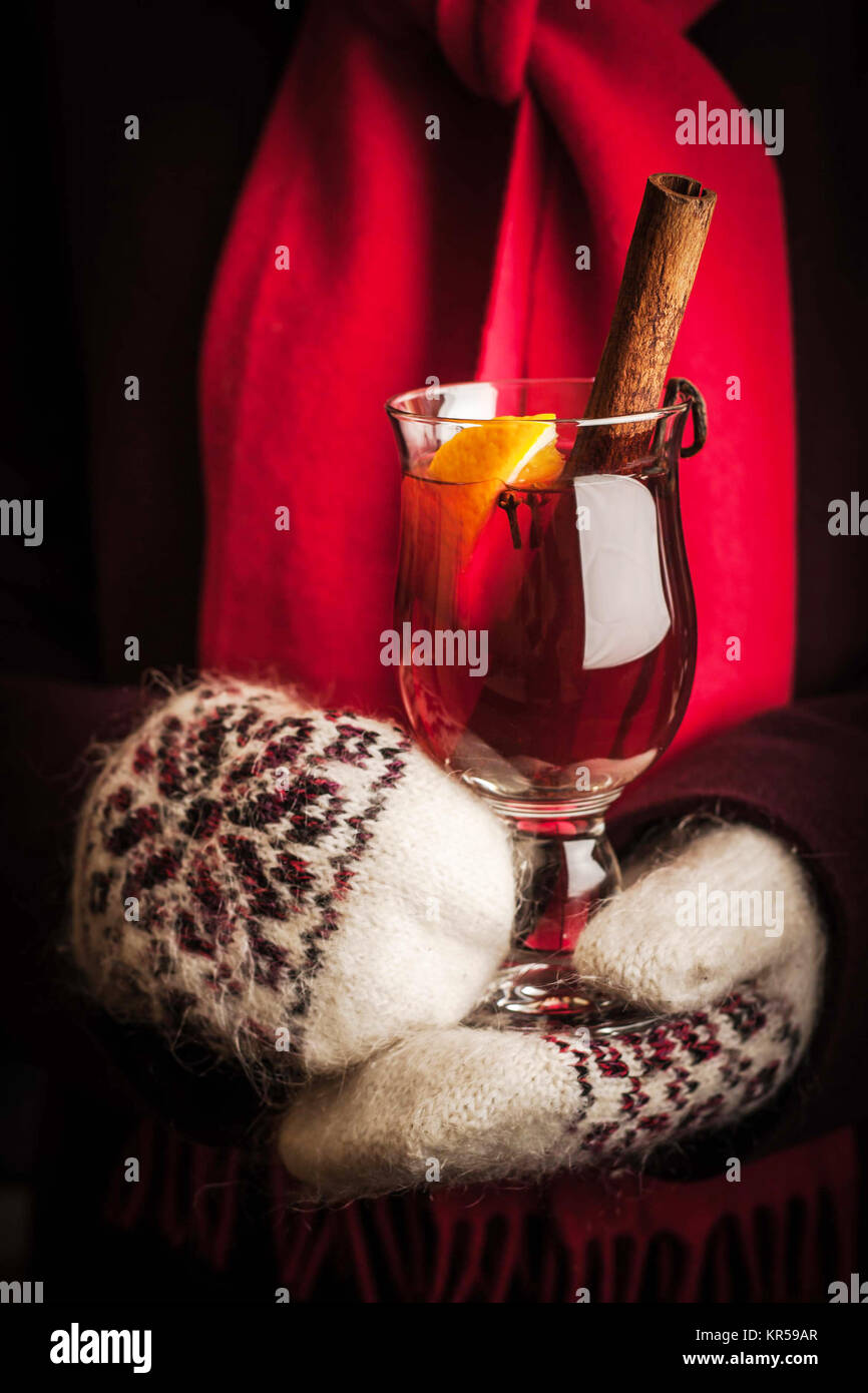 Mulled whine in the hands in knitted mittens vertical Stock Photo