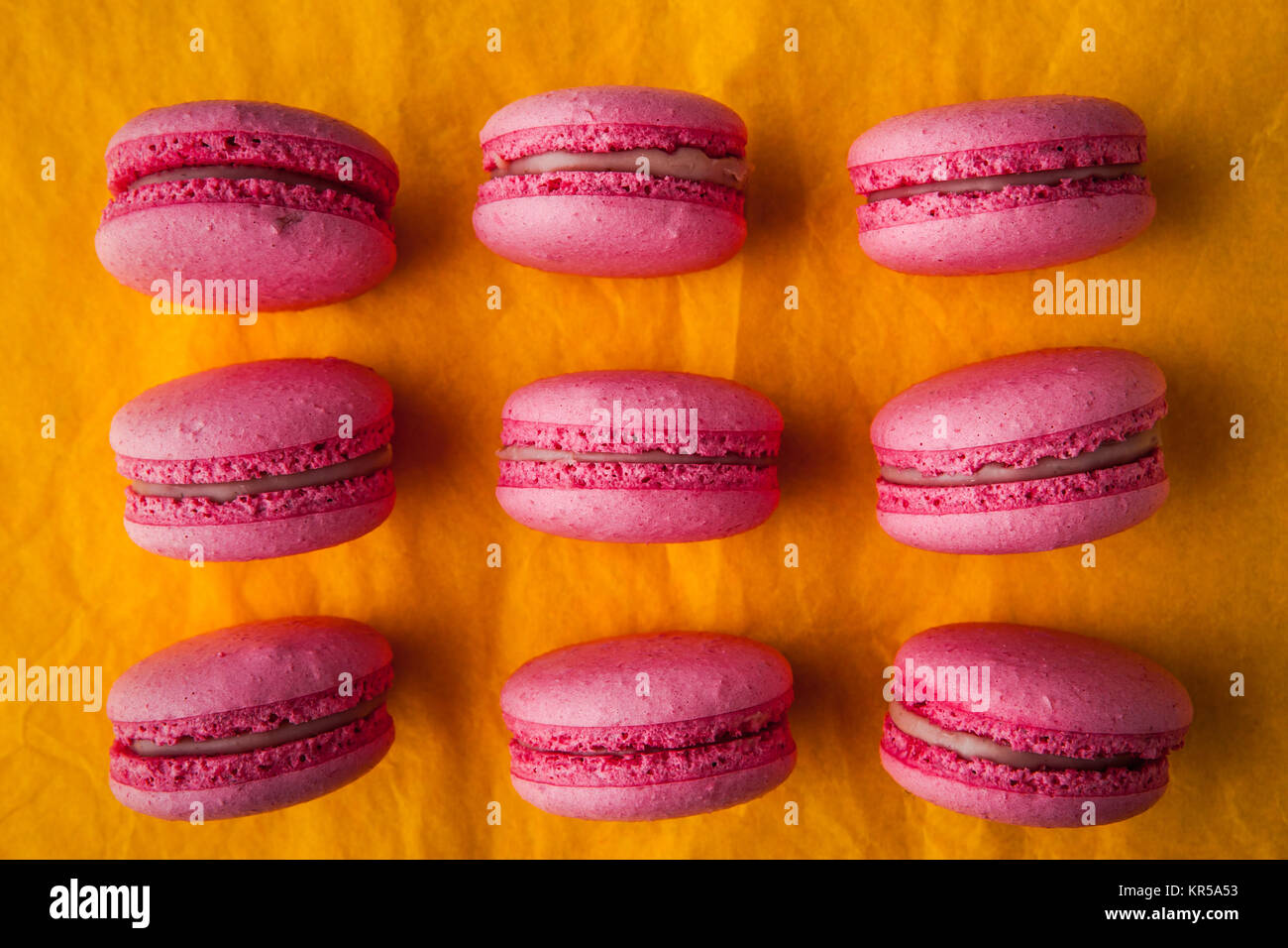 Pink macaroon on a yellow tablecloth Stock Photo
