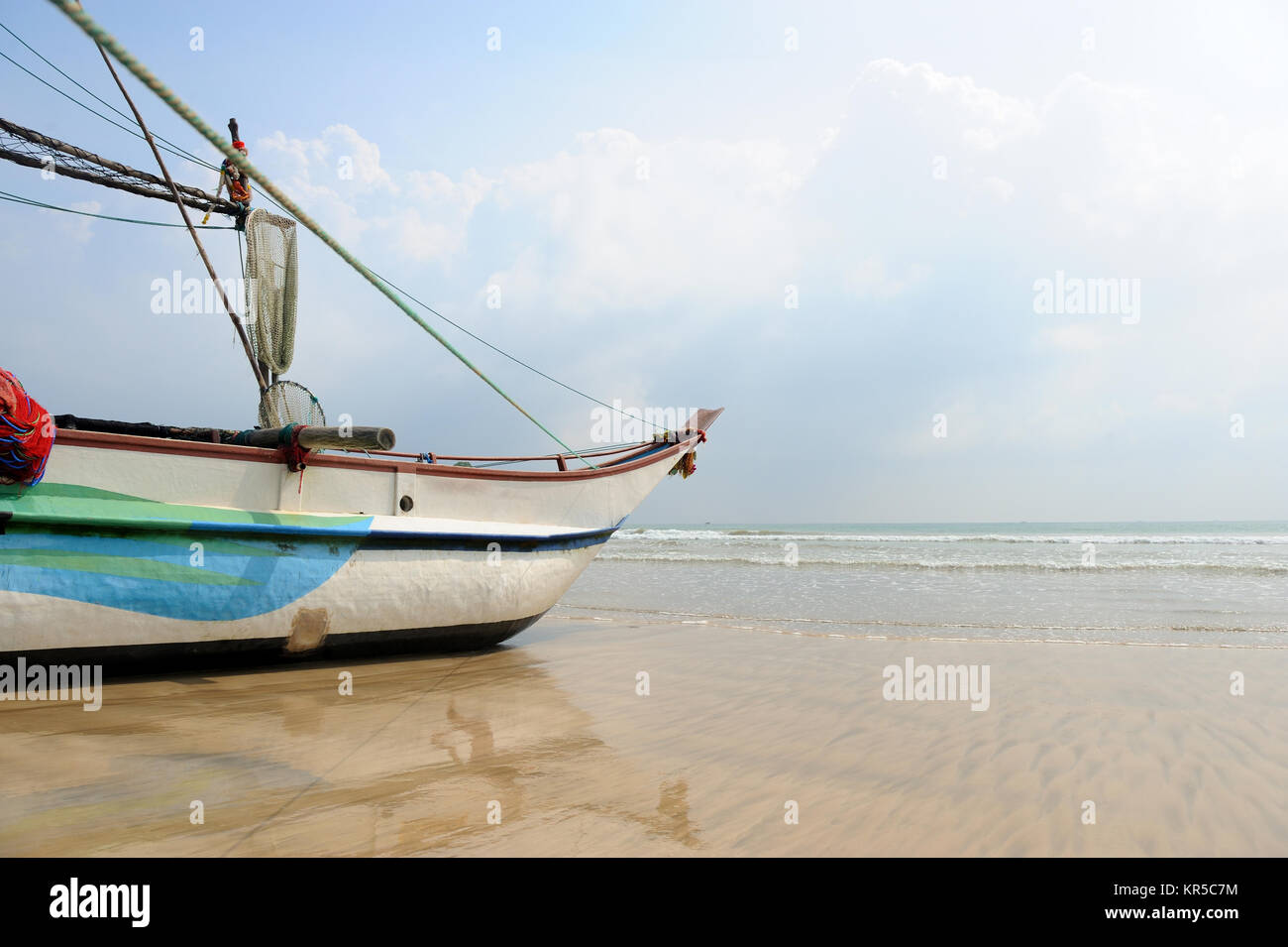 Fishing boats resting on empty beach in Sri Lanka Stock Photo