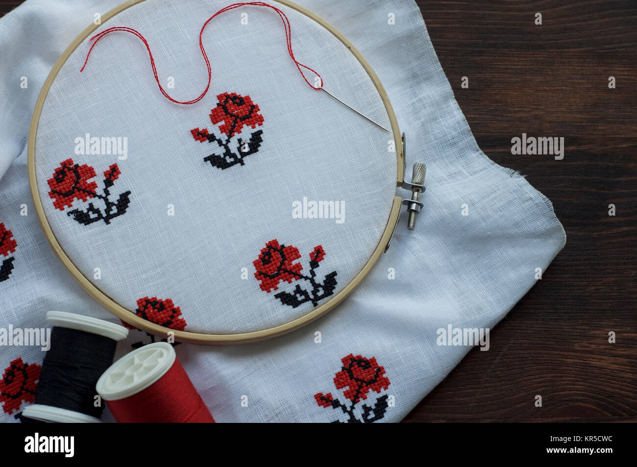 White cloth with handembroidered with a cross in the hoop Stock Photo