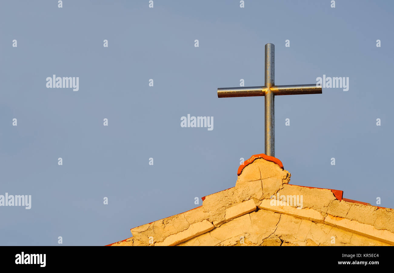 cross of metal on a chapel Stock Photo