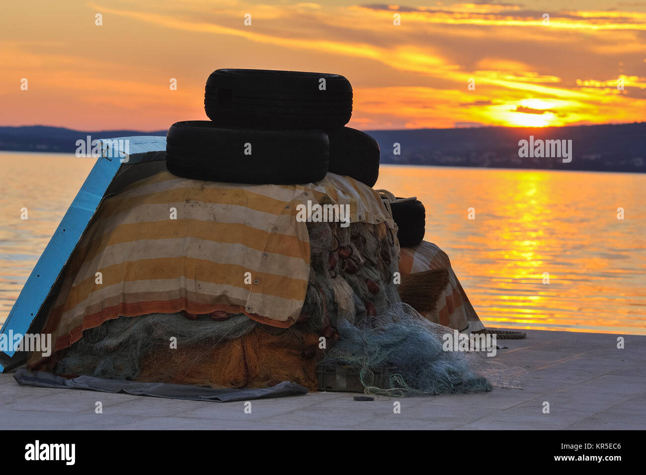 fishing nets at the mole with tires complained Stock Photo