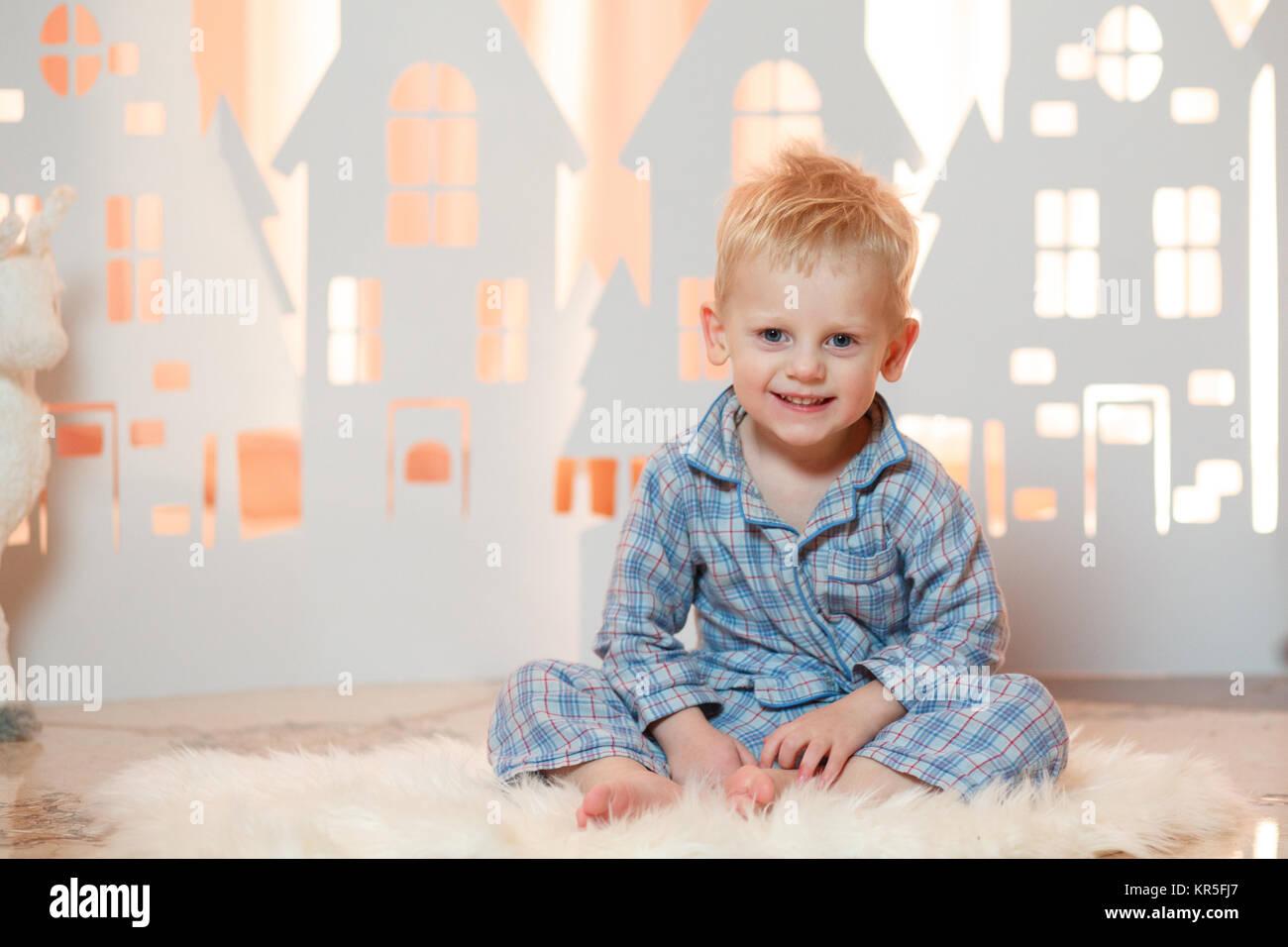 Cute Blonde Hair Little Boy In Sleepwear Near Christmas Toy