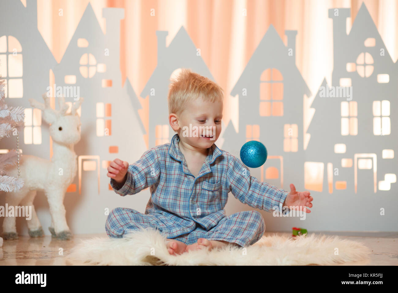 Cute Blonde Hair Little Boy In Sleepwear Near Christmas Toy