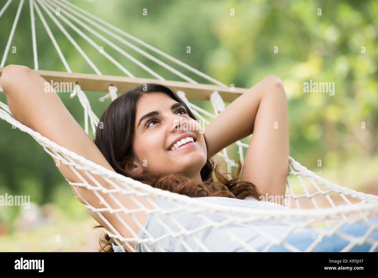 Happy Woman Relaxing In Hammock Stock Photo - Alamy