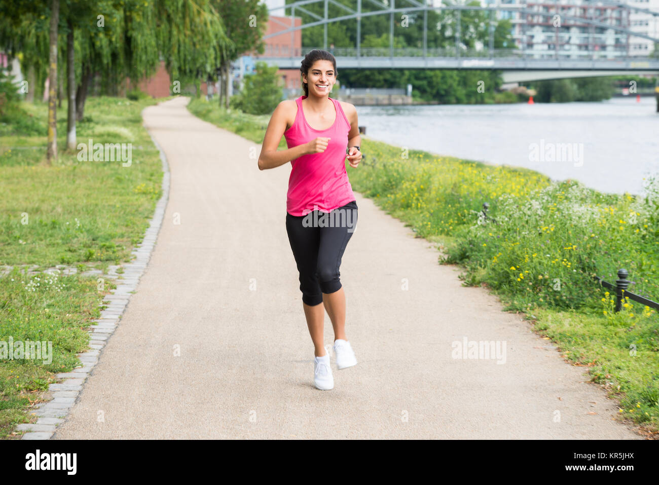 Athletic Young Woman Jogging Stock Photo - Alamy