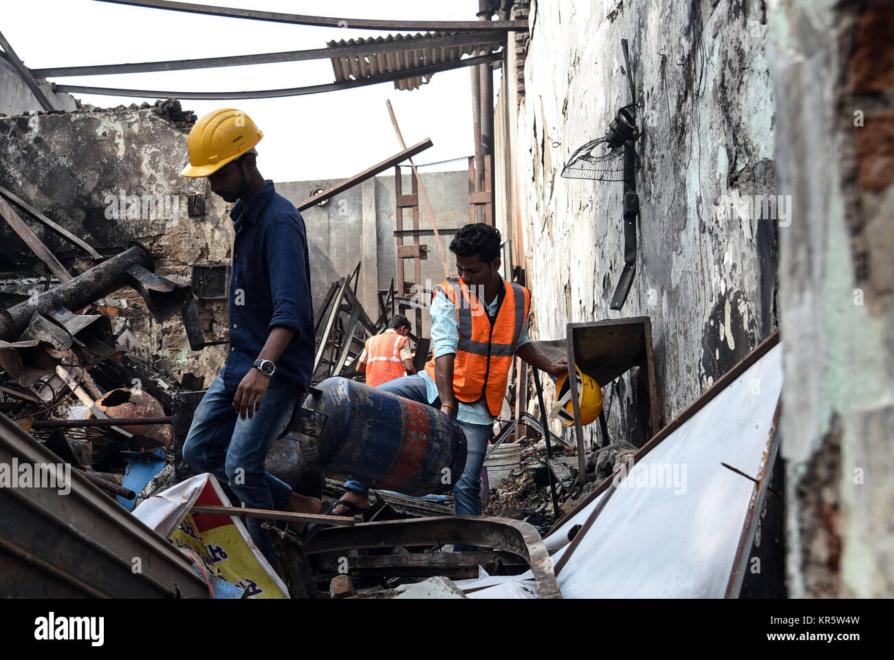 Mumbai. 18th Dec, 2017. Workers clear debris from a fire accident in Mumbai on Dec. 18, 2017. At least 12 people were killed and four others injured in a fire at a shop in India's financial capital Monday, police said. Credit: Xinhua/Alamy Live News Stock Photo