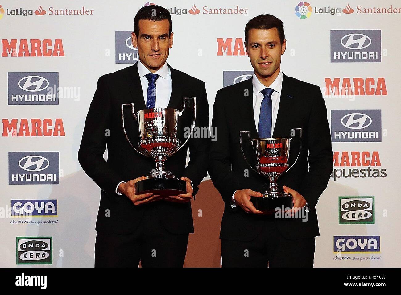 Spanish referees Juan Martinez Munuera (L) and Adrian Cordero Vega (R) pose  with the Guruceta Award to the best referees in La Liga and La Liga 123  (Spanish Second Division) during 2016-2017
