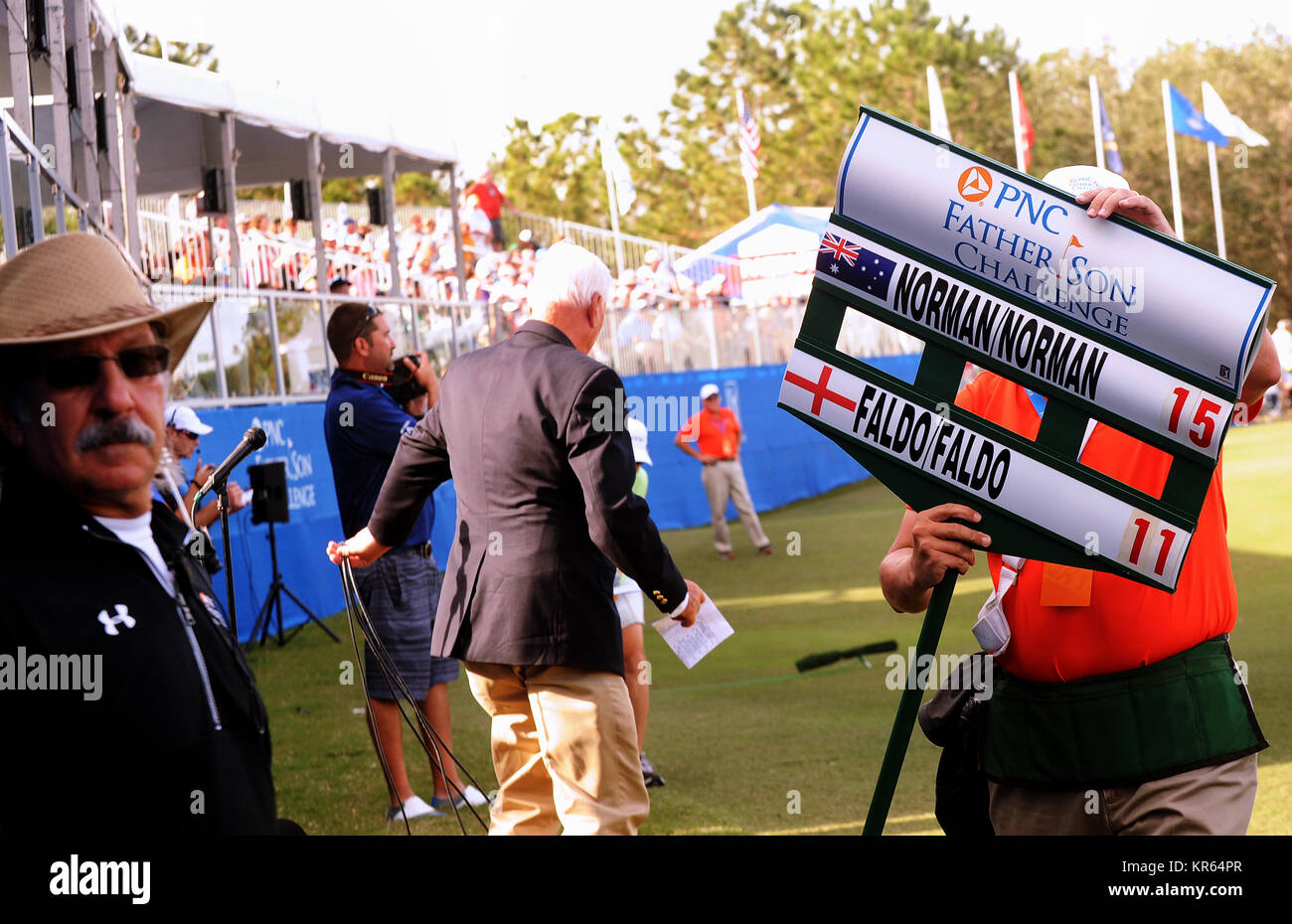 Orlando, United States. 17th Dec, 2017. December 17, 2017 - Orlando, Florida, United States - A tournament worker carries a sign with players' names on it as Sir Nick Faldo and his son, Matthew Faldo compete on the 18th green in the second and final round of the 2017 PNC Father Son Challenge golf tournament on December 17, 2017 at the Ritz-Carlton Golf Club in Orlando, Florida. Faldo and his son finished tied for 16th place. Credit: Paul Hennessy/Alamy Live News Stock Photo