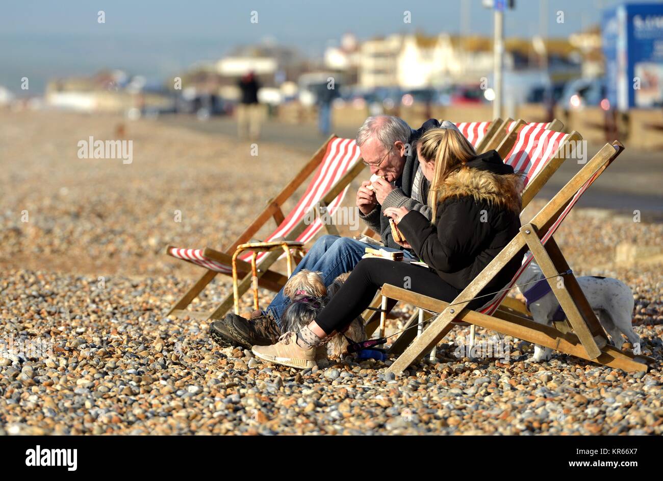 People enjoying rare winter sun on Seaford beach, UK Stock Photo