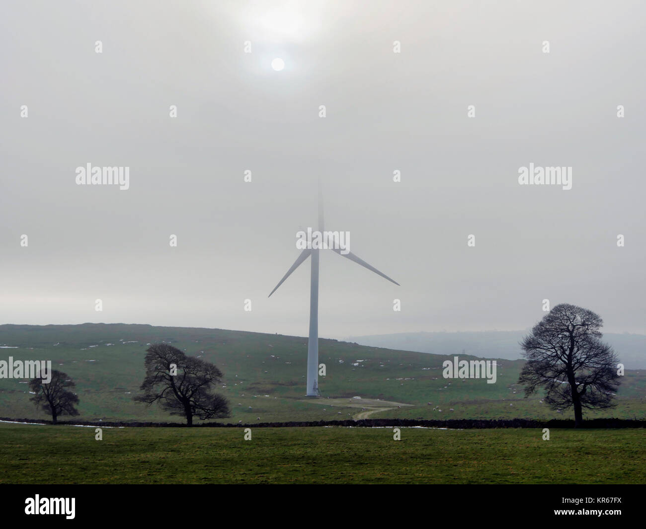 Brassington, Derbyshire. 19th December, 2017. UK Weather wind turbines turning in the cold mist near Brassington, Harborough Rocks & the High Peak Trail, Derbyshire, Peak District National Park Credit: Doug Blane/Alamy Live News Stock Photo