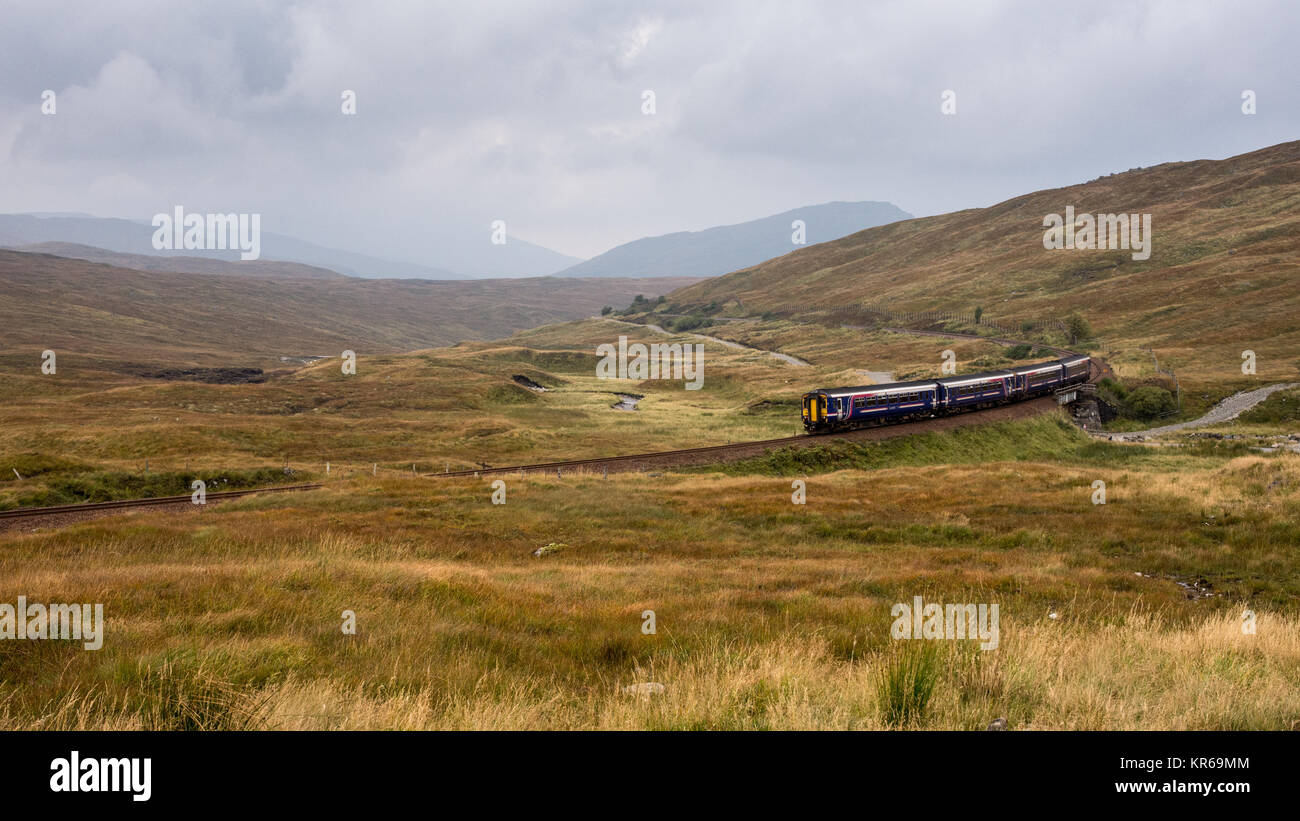 Corrour, Scotland, UK - September 26, 2017: A pair of Scotrail Class 156 'Sprinter' passenger trains climb from Fort William onto the wetland peat bog Stock Photo