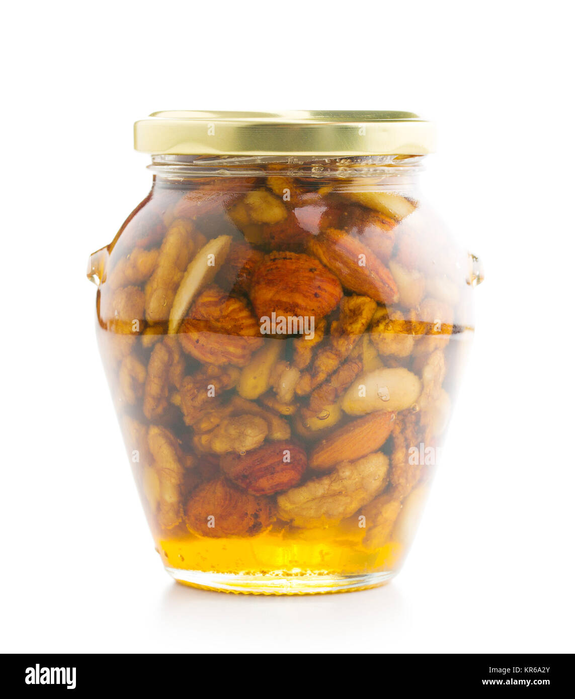 Jar of nuts in honey isolated on white background Stock Photo