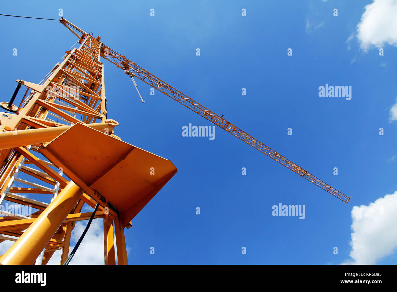 a yellow crane against the blue sky Stock Photo