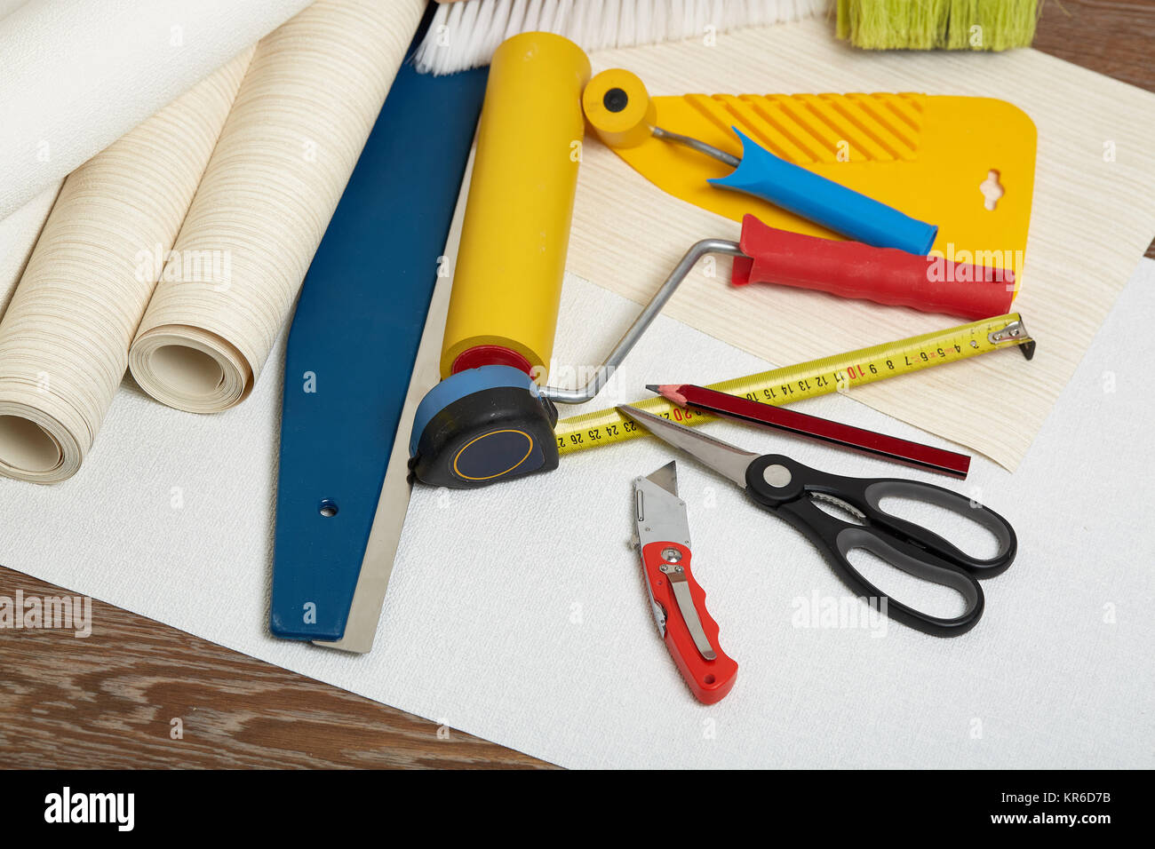 Rolls of wallpapers and various tools for wallpapering Stock Photo Alamy
