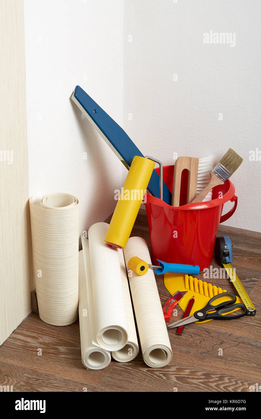 Rolls of wallpapers and various tools for wallpapering Stock Photo Alamy