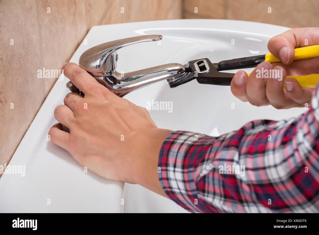 Plumber Installing Faucet Of Sink Stock Photo Alamy