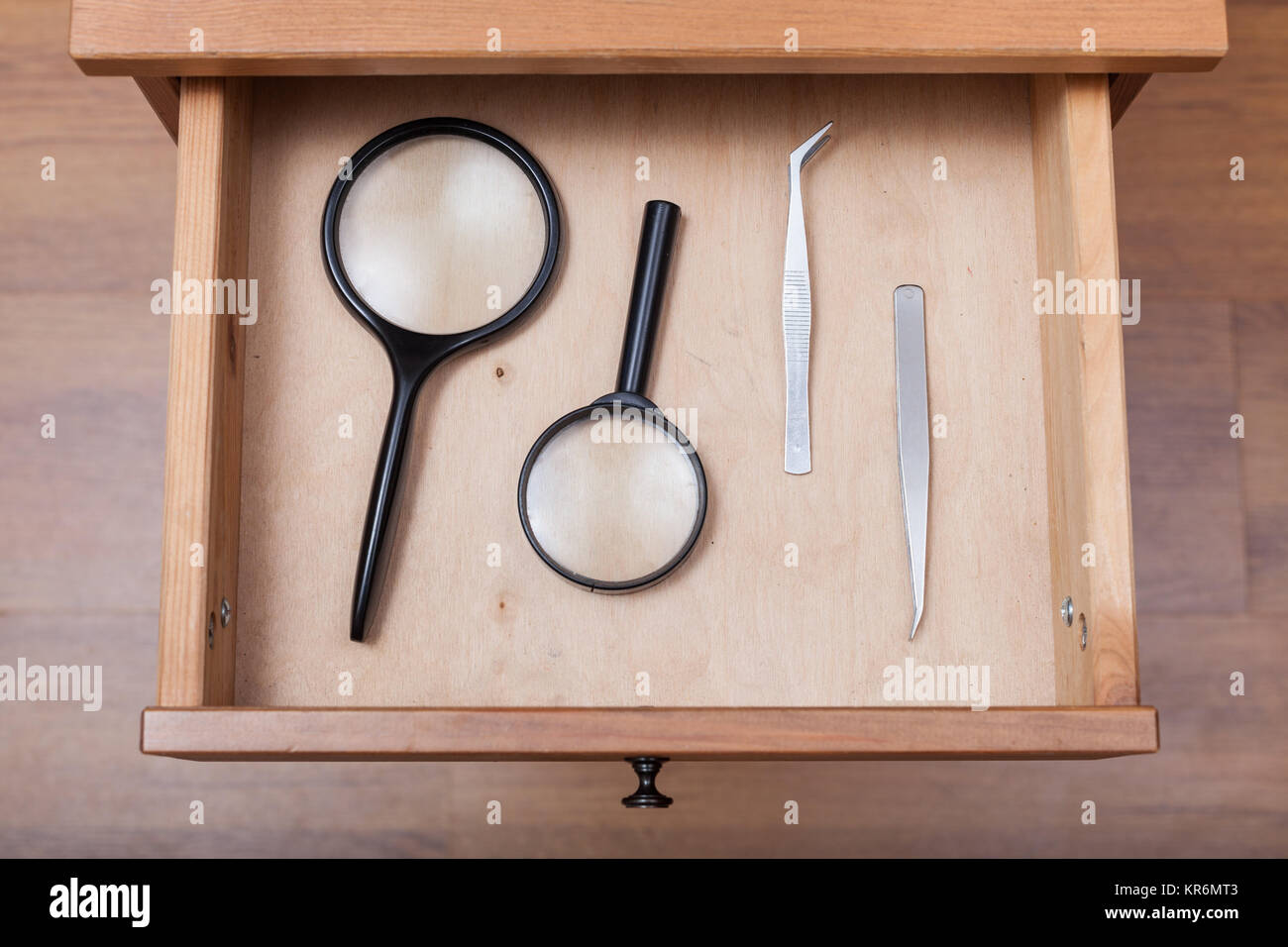 magnifying glasses and tweezers in open drawer Stock Photo Alamy