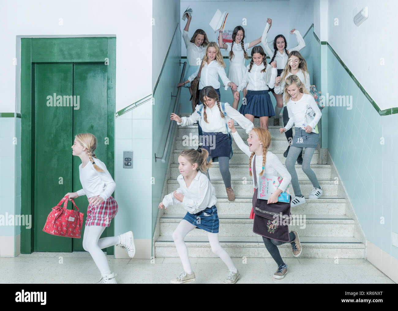 Kids rushing down the stairs after class. Stock Photo