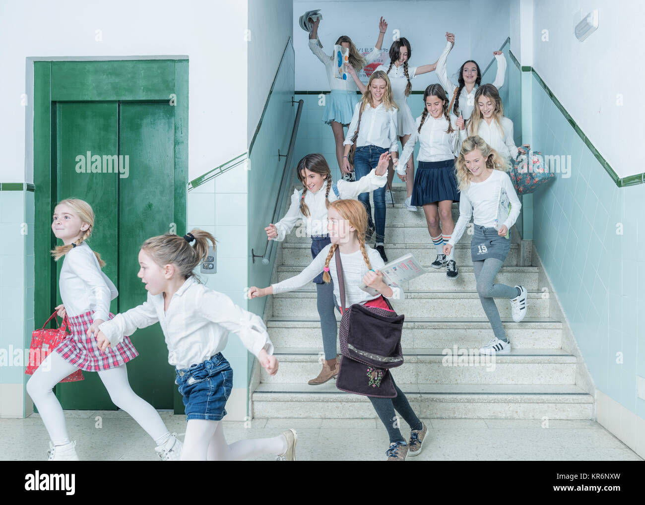 Kids rushing down the stairs after class. Stock Photo