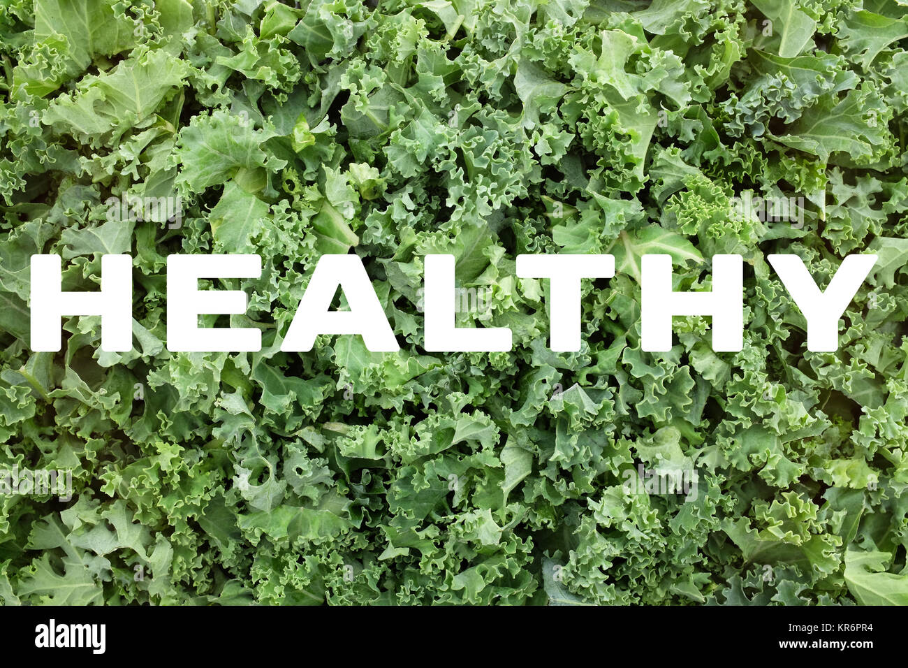 HEALTHY text over shredded kale leaves background Stock Photo