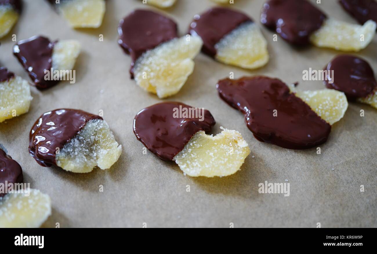 Making candied ginger dipped in dark chocolate Stock Photo Alamy