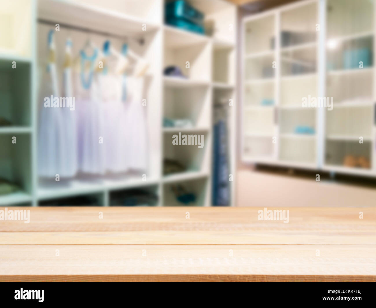 Wooden empty table in front of blurred closet room Stock Photo
