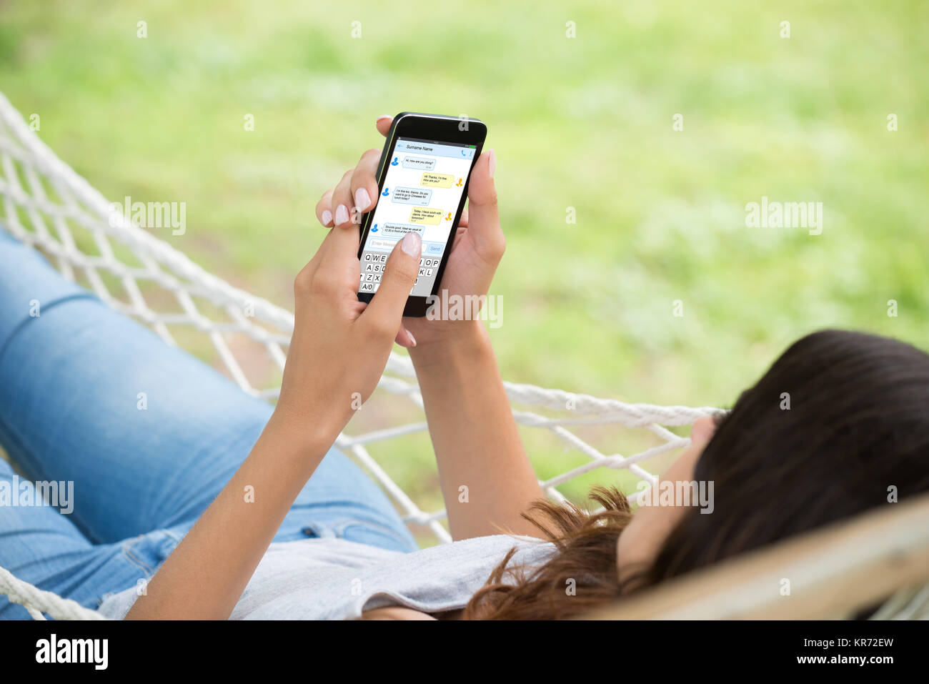 Woman Typing Text Message On Smartphone Stock Photo - Alamy