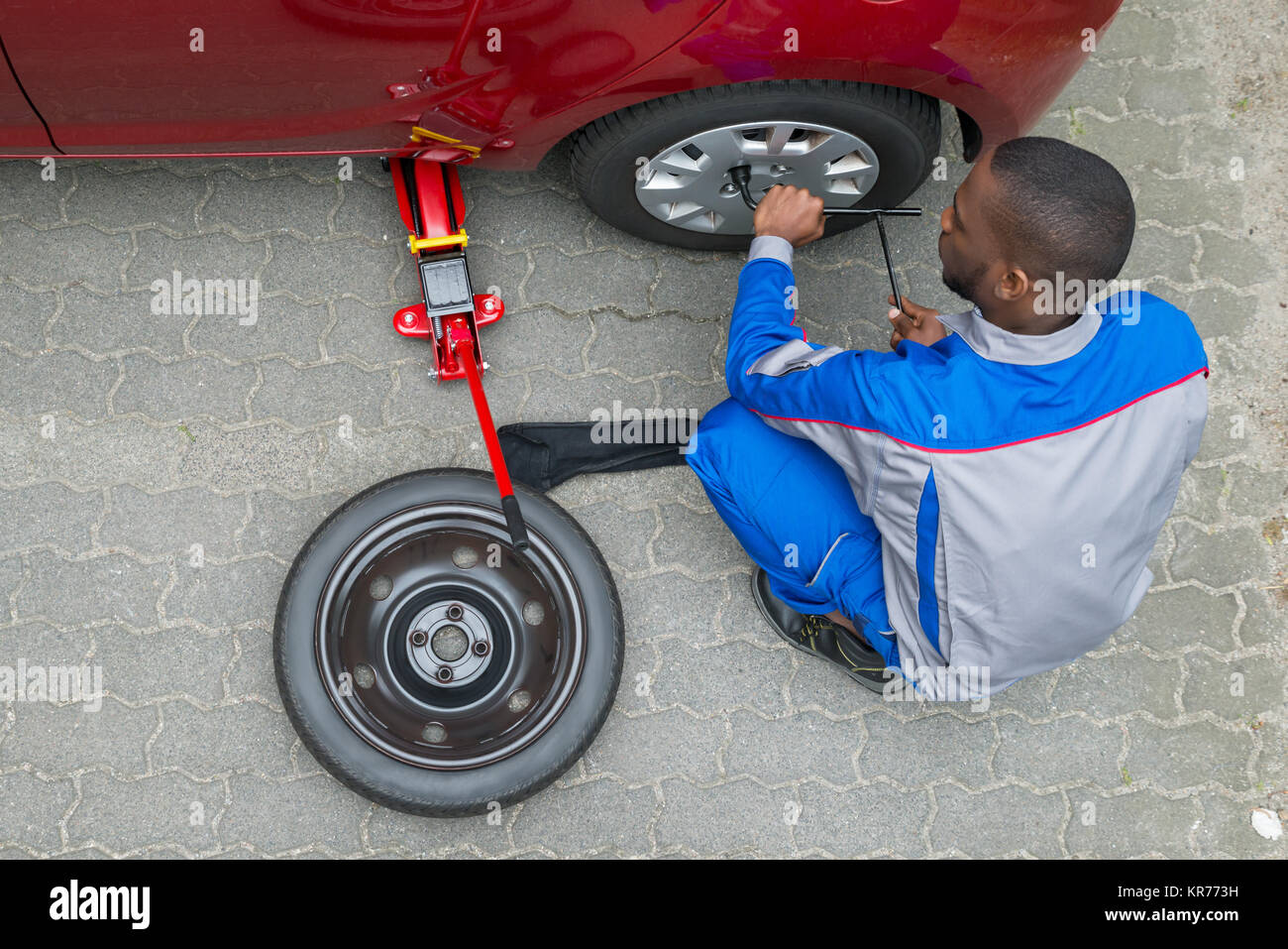 Mechanic Changing Tire With Wrench Stock Photo Alamy