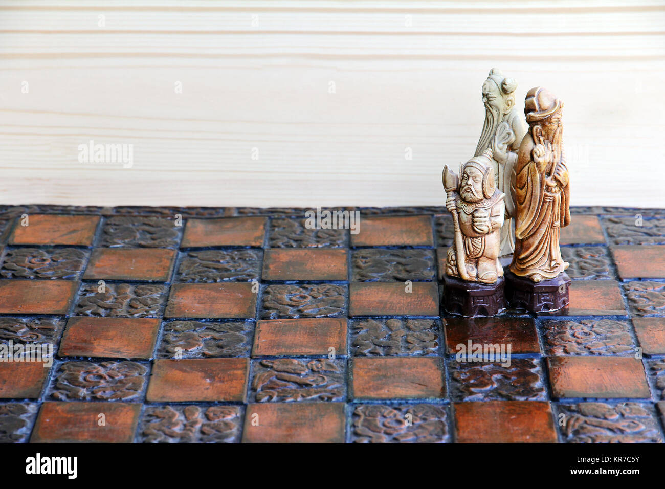three chess pieces on a chessboard. together and cohesion in the game and in life Stock Photo