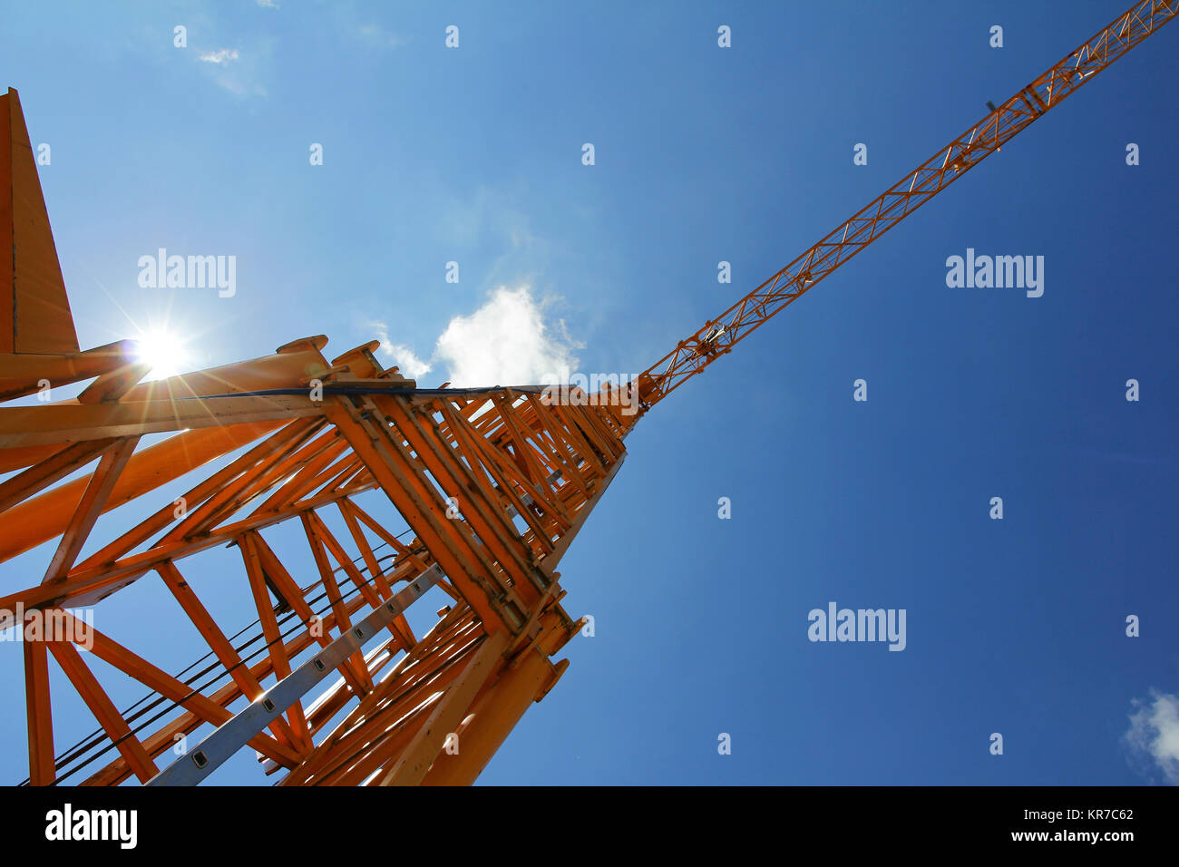 a yellow crane against the blue sky Stock Photo
