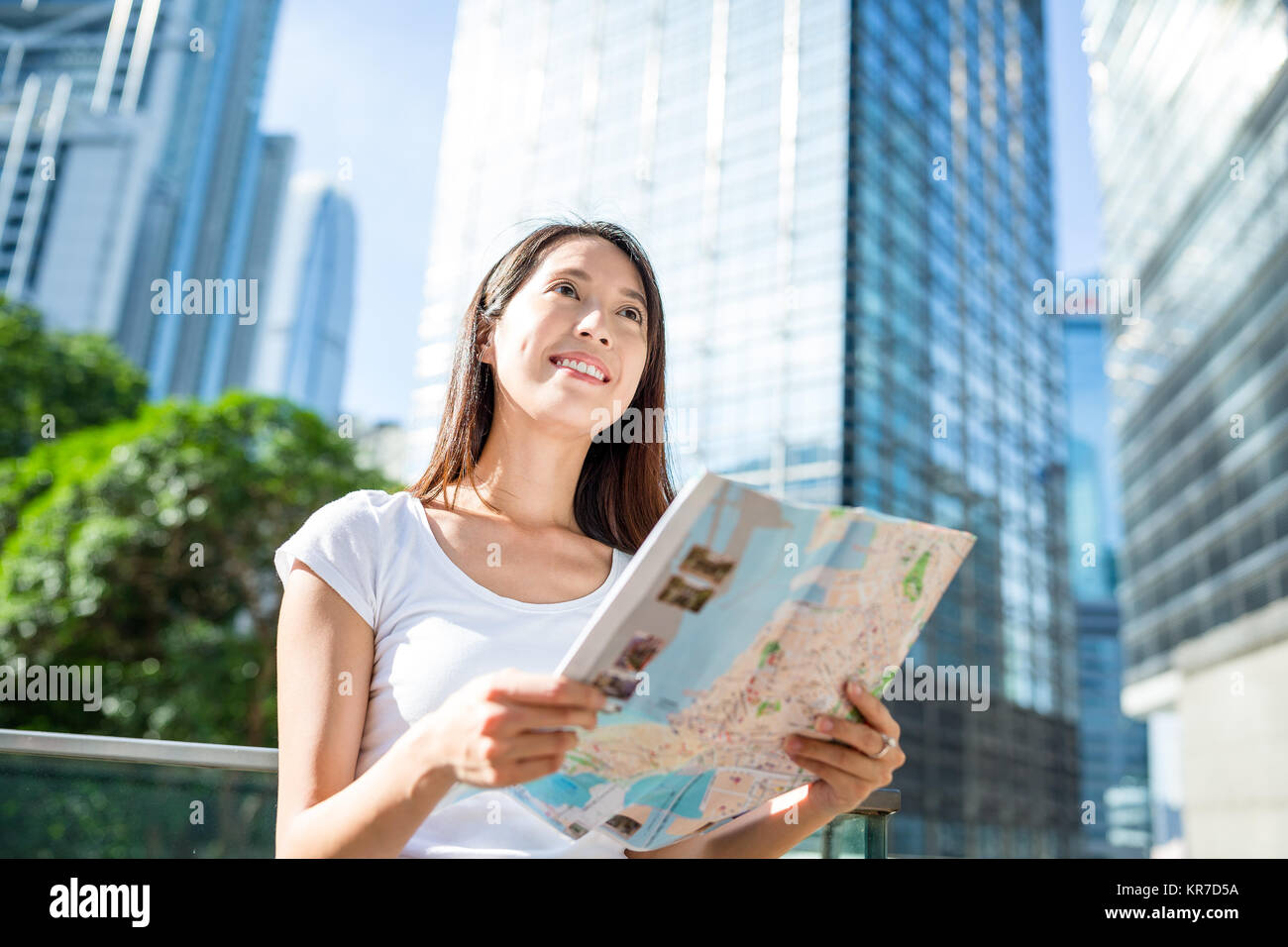 Woman looking at city map in Hong Kong city Stock Photo - Alamy