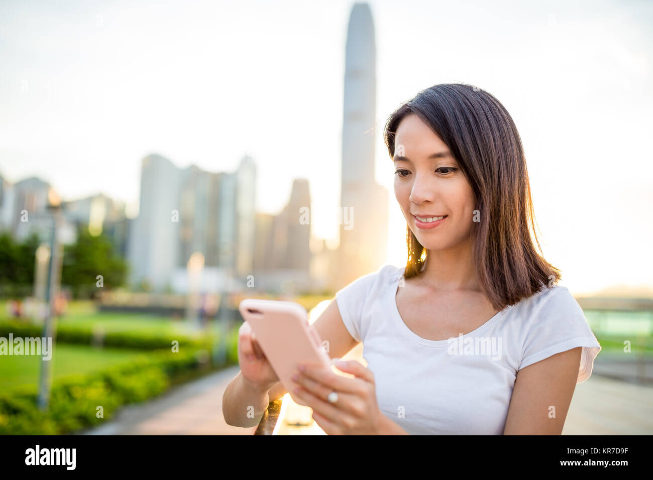 Woman using cellphone in Hong Kong city Stock Photo - Alamy